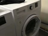a washer and a dryer in a small room