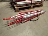 several red and white skis sitting on top of a pallet in a warehouse