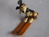 a small figurine of a dog on a snowboard