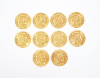 several gold coins are arranged in the shape of a heart on a white surface