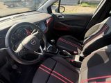 the interior of a small car with red trims and a steering wheel