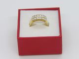 yellow gold ring with diamonds in a red box on a white surface