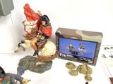 a figurine of a man riding a horse next to a box of coins
