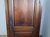a wooden cabinet with a mirror on top of it