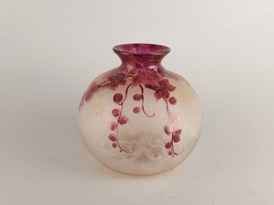 a small glass vase with a pink flower design on it