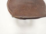 a brown leather purse sitting on top of a white table