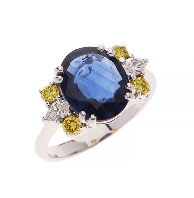 an oval blue sapphire and yellow sapphire ring with diamond accents