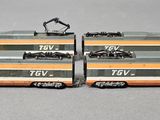 two toy trains that are sitting side by side