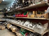 many different types of tools on the shelves in the shop
