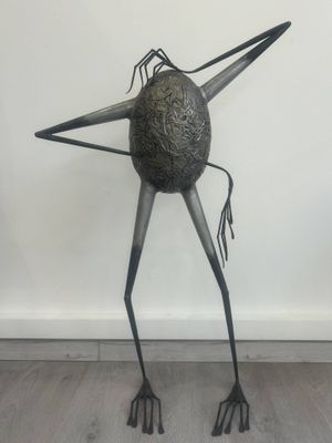 an image of a sculpture of a bird on a wooden floor