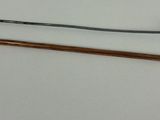 two different types of knitting needles on a white surface