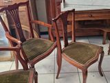 four chairs in a room with a mirror on the wall
