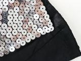 a close up of a black skirt with silver sequins on it