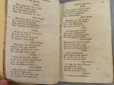 someone is holding an open book with a poem written in it