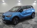 a blue opel suv parked in a room with a checkered floor