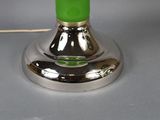 a green lamp that is on top of a table