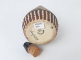 an old baseball sitting on top of a table next to a cork stopper