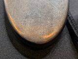 a close up of a pocket watch on a black cloth
