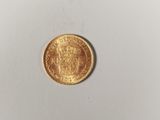 a close up of a gold coin on a white surface