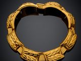 an image of a gold bracelet on a black background