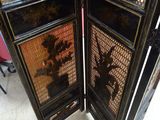 two black folding screens that are sitting on a table