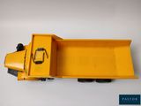 an image of a yellow toy truck on a white surface