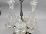 three glass decanters on a stand with a key in the middle of them