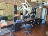 une photo d'un salon de coiffure avec un mur en briques