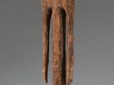 an image of a wooden sculpture of a man on a block