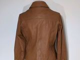 the back of a brown leather jacket on a mannequin mannequin mannequin mannequin mannequin mannequin mannequin manne