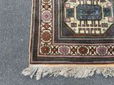 a rug on the ground with a cat laying on top of it