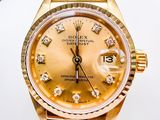 a gold rolex watch with diamonds on the dial
