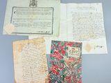 several old papers and a book on a table