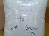 a white pillow sitting on top of a table next to a wall