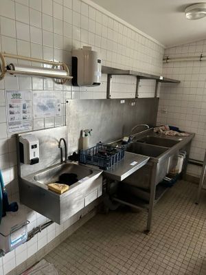 a kitchen with a sink, stove, and other items in it
