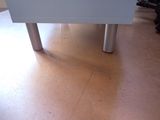 a white table with a black cat sitting on top of it