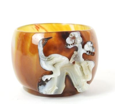 a brown and white bowl with an elephant and flowers on it