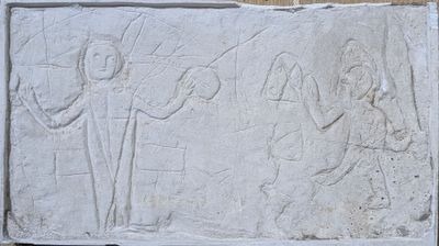 an image of a stone relief of a man and a woman