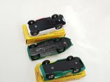 three toy cars sitting on top of each other on a table