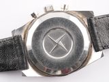 a close up of a watch on a white surface