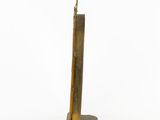 an image of a tall metal object on a white surface