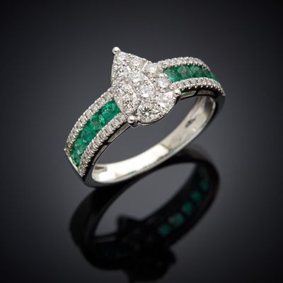 a white gold ring with emerald and diamonds