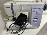 a white sewing machine sitting on top of a counter