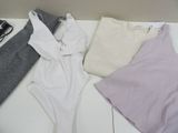 three pieces of clothing laid out on a white table