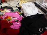 a pile of clothes that is sitting in a suitcase