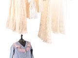 three mannequins with dresses hanging on a clothes rack