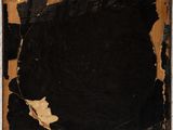 an old picture frame with a torn piece of paper hanging on a wall