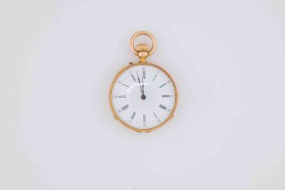 a gold pocket watch with a white face on a white surface