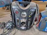 a portable air compressor sitting on the floor next to other equipment