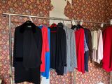 a lot of clothes hanging on a rack in a room